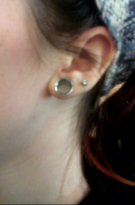McIntyre shows off her stretched lobes  - 00g [3/8", about the width of a small pinky finger].